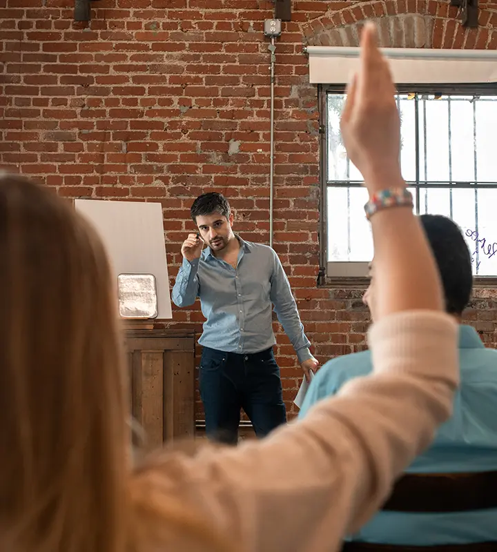 Adult student raising her hand in classroom